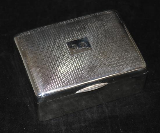 An engine turned silver cigarette box and a silver bracelet